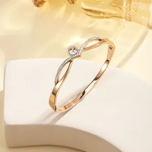 Detail of 18k gold plated titanium steel bracelet with sparkling center zircon stone