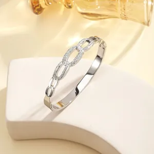 Detail of silver titanium bangle with interlocking pave-set cubic zirconia crystals