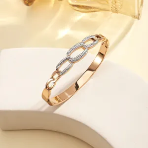 Detailed macro view of rose gold plated titanium steel bangle with inlaid crystals