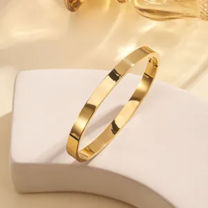 Modern minimalist 18k gold plated stainless steel open bangle with a polished mirror finish