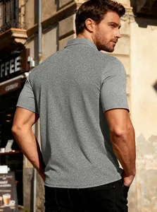 Outdoor street view of the back profile of a gray textured knit short sleeve polo shirt