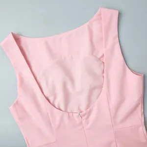Detail of light pink sleeveless dress with smooth texture and concealed back zipper