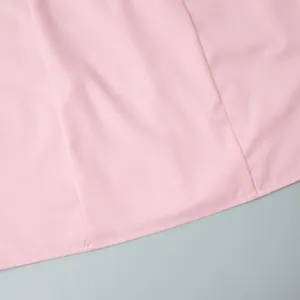 Close-up detail of pink sleeveless blazer dress showing high-quality stitching and fabric texture