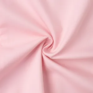 Macro shot of high-quality pink twill fabric showing soft texture and fine weaving details