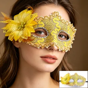 Detail of yellow lace masquerade mask with feathers, floral accents and pearl trim