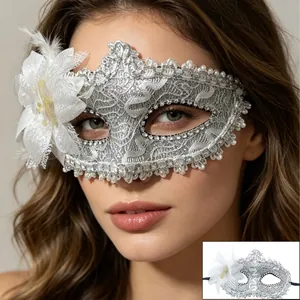 Close-up of silver lace masquerade mask with faux pearls and white floral feather detail