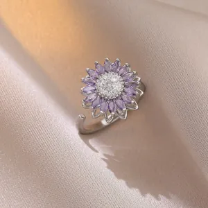 Macro detail of rotating sunflower ring with purple crystals and adjustable silver band
