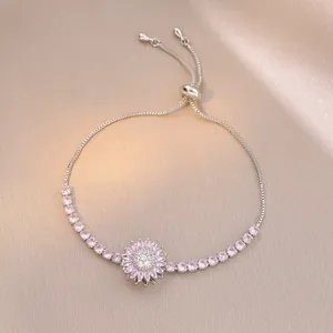Detail of adjustable silver bracelet with pink zircon sunflower on champagne silk
