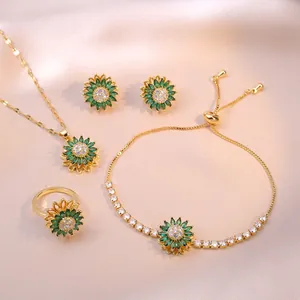 Golden sunflower jewelry set with green crystals including necklace, bracelet, and ring