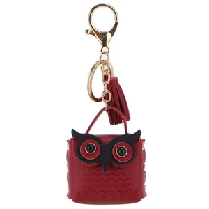 Red leather owl keychain bag charm with golden metal clasp and decorative tassel