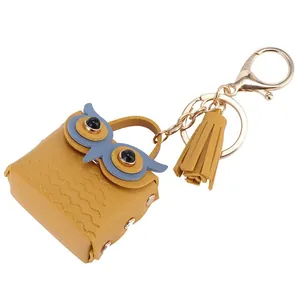 Ginger yellow owl coin purse keychain with faux leather tassels and gold metal clip