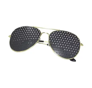 Detail of golden aviator pinhole glasses featuring multiple fine visual correction holes