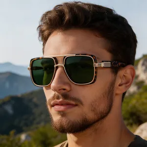 Close-up of tortoise shell frame sunglasses with gold metal engraving and green lenses