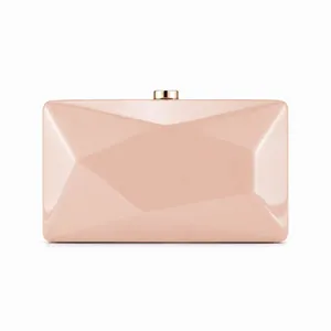 Close-up of pale pink evening clutch featuring geometric faceted surface and gold clasp