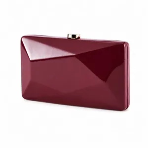 Detailed view of the burgundy geometric faceted evening clutch with golden metal clasp