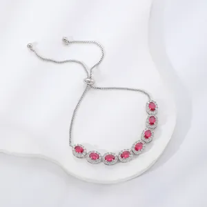 Adjustable silver bracelet with oval red gemstones and sparkling zircon accents