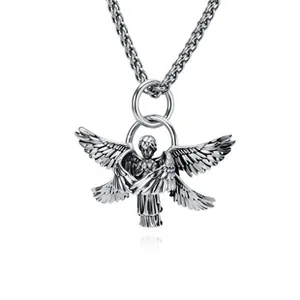 Macro shot of retro silver archangel pendant with detailed six-wing texture on twist chain