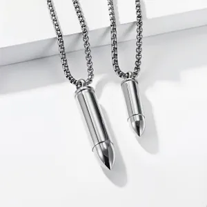 Detailed macro view of two polished gold bullet pendants with high-shine box chains