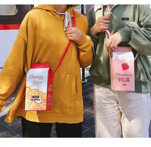 Street view detail of creative milk carton crossbody bags with orange and strawberry print