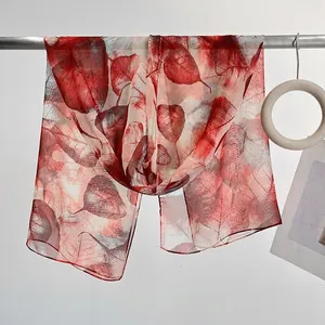 Lightweight sheer long scarf featuring a vintage reddish-brown leaf print and silk texture