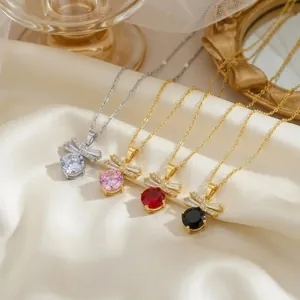 Elegant bowknot zircon necklace set in gold and silver finishes on silk fabric