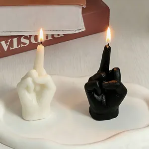 Creative middle finger gesture scented candles in black and white on a tray