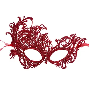 Close-up of red lace masquerade mask featuring intricate floral vine textures and satin ties