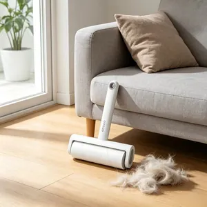 Close-up of ecoco lint roller on gray sofa removing pet hair from wooden floor