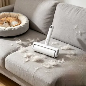 Detail of Ecoco lint roller removing pet hair from a grey fabric sofa at home