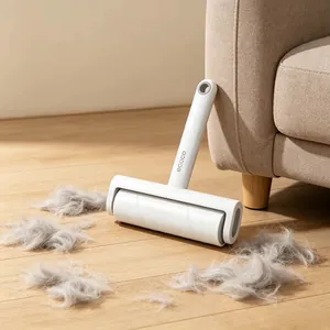 Macro shot of white ecoco lint roller removing pet hair from wooden floors and sofas