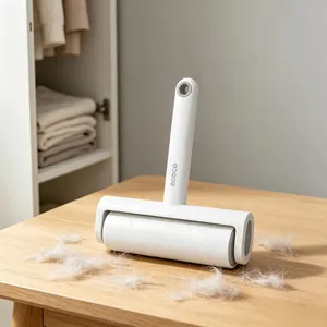 Close-up of lint roller on wood table removing white hair with minimalist white design