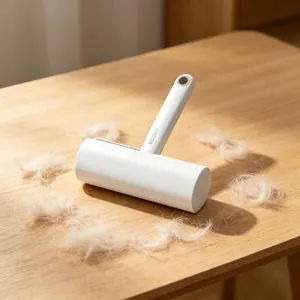 Ecoco handheld lint roller for pet hair removal on a warm wooden tabletop surface