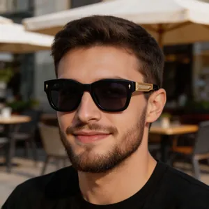 Close-up of black acetate sunglasses frame with gold embossed metal temple hardware