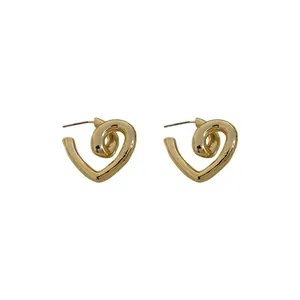 Elegant gold twisted heart stud earrings with a polished metallic finish on white background