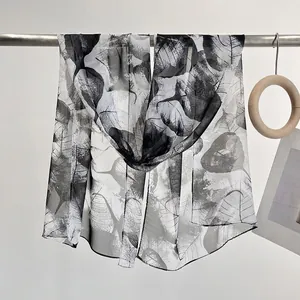 Lightweight sheer chiffon scarf featuring realistic black and white leaf vein patterns