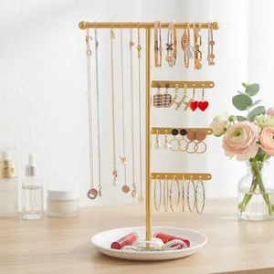 Multi-tier gold metal jewelry stand with white base tray for necklace and earring storage