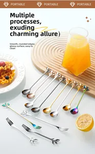Close-up of leaf-shaped stainless steel spoons and dessert forks in assorted metallic colors