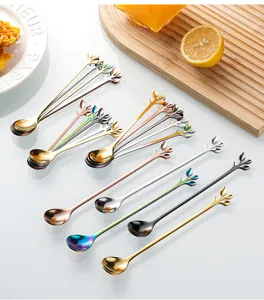 Detail of leaf-shaped handle on colorful stainless steel dessert spoons for coffee