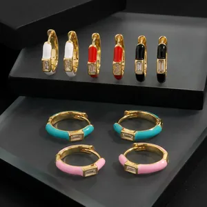 Detailed macro view of minimalist colorful enamel hoop earrings with inlaid zircons