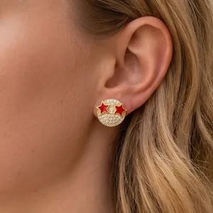Zircon paved round earrings with red enamel stars and 18K gold plated copper