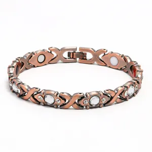 Macro detail of red copper magnetic bracelet with sparkling crystals and health magnets