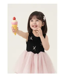 Detail of girls sleeveless tutu dress featuring a black bodice and pink mesh layered skirt
