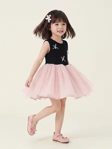 Sleeveless girl's dress with black bodice and pink tulle skirt featuring a bow accent