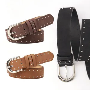 Detail of vintage western style belts with silver studs and metal buckles in three colors