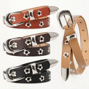 Detail of vintage western waist belts with hollowed floral metal ornaments and silver buckle