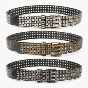 Detail of three-row hollow metal eyelet belts with triple-prong buckle in vintage punk style