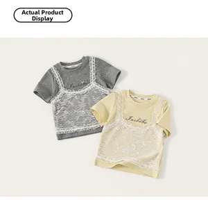 Detail of girls' layered t-shirt with delicate white floral lace overlay and logo