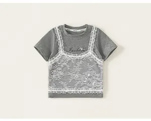 Detail of girls grey faux-layered tee with white floral lace and bow decoration