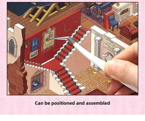 Detailed view of applying miniature stickers to a dollhouse scene using tweezers