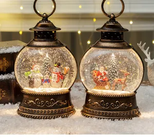 Detail of vintage Christmas lanterns with Santa and Snowman in a snowy winter scene